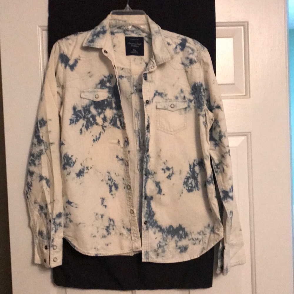 Tie-dye shirt with snap buttons.